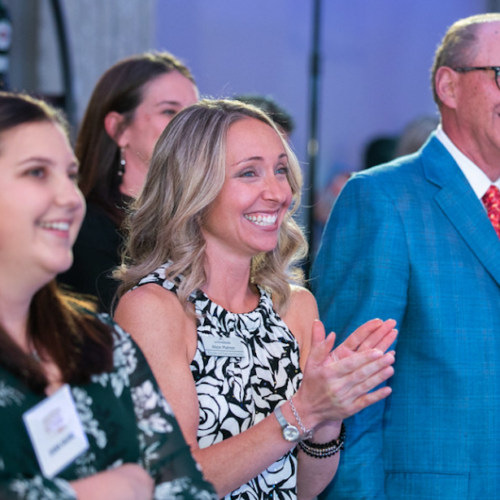A group of people clapping at a fundraiser