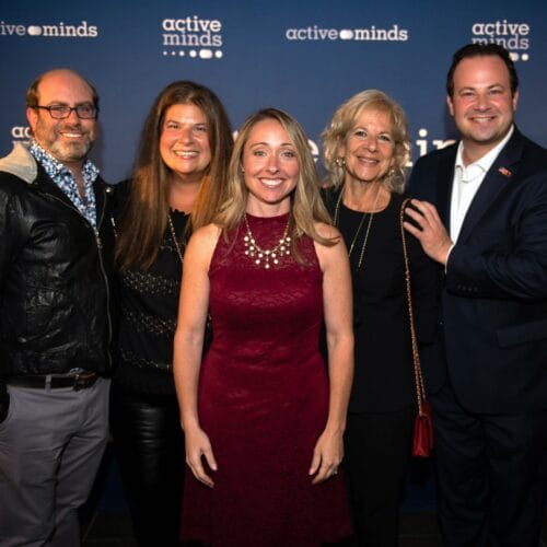 Group photo of the Feld & Friedson families, standing with Alison Malmon, founder & CEO of Active Minds