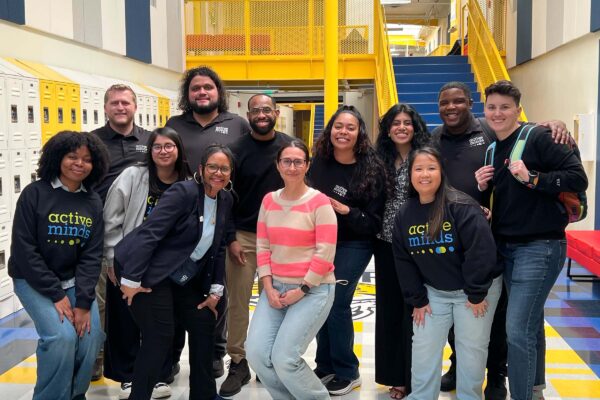 Active Minds staff and Central City Value High School representative pose for group photo